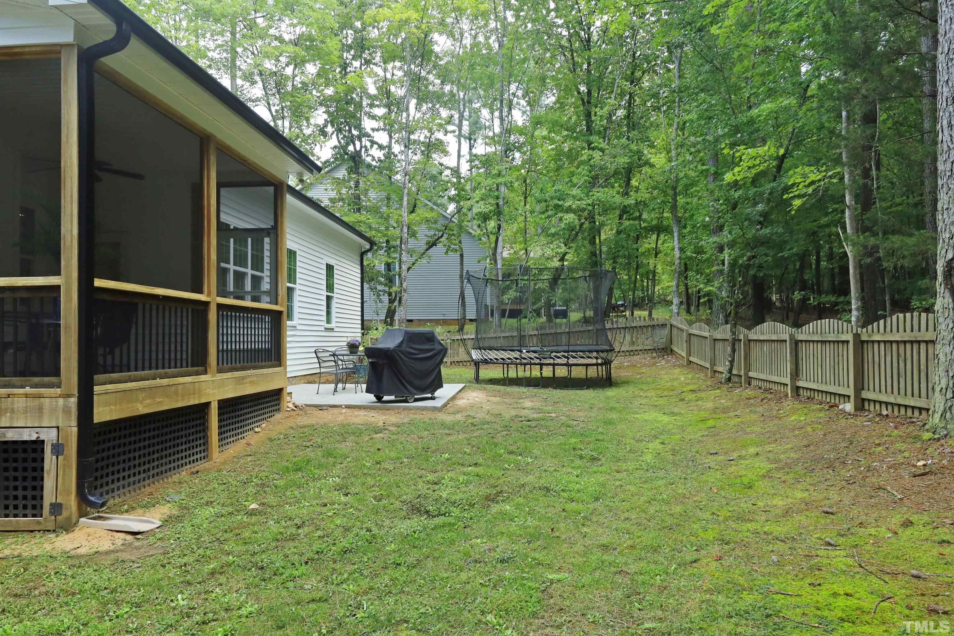 3630 Pine Needles Drive Wake Forest, NC 27587 - Photo 44 of 47 a view of backyard with wooden fence and large trees
