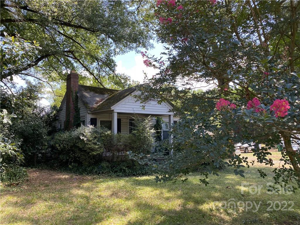 6313 Tuckaseegee Road Charlotte, NC 28208 - Photo 1 of 15 a view of a house with a tree in the yard