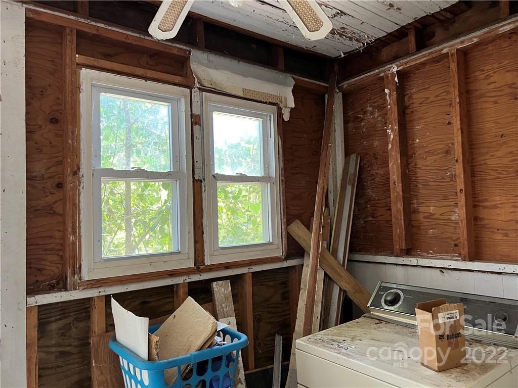 6313 Tuckaseegee Road Charlotte, NC 28208 - Photo 13 of 15 a bathroom with a sink mirror and a window