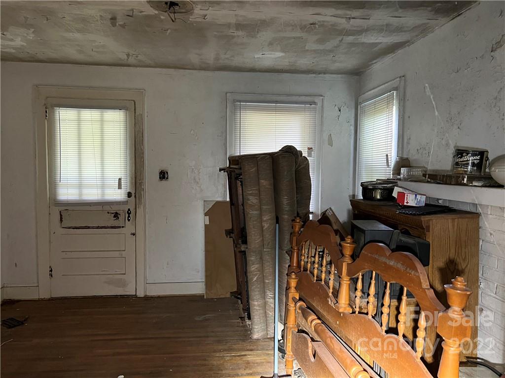 6313 Tuckaseegee Road Charlotte, NC 28208 - Photo 14 of 15 a view of a workspace with furniture and wooden floor