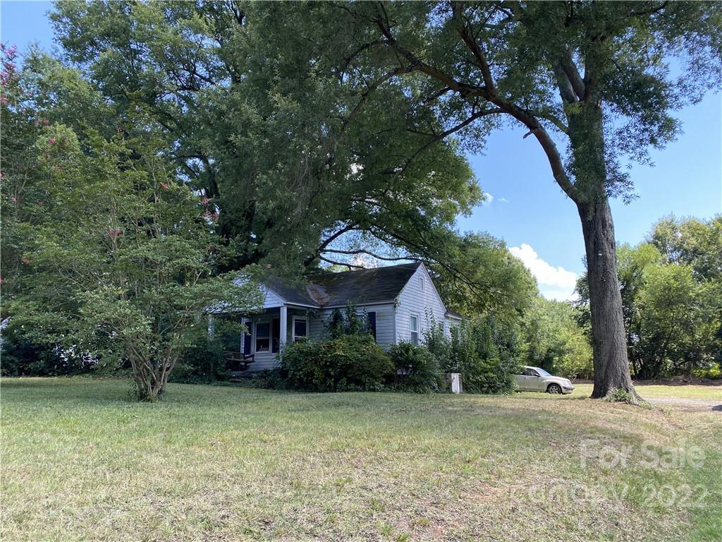 6313 Tuckaseegee Road Charlotte, NC 28208 - Photo 3 of 15 a front view of a house with a garden