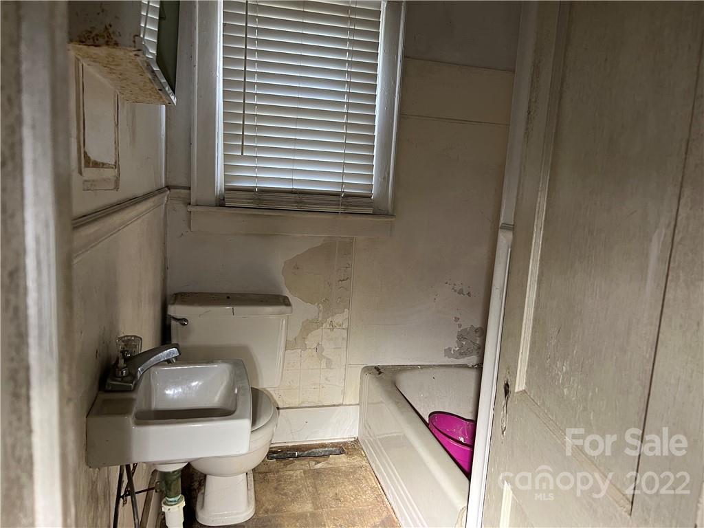 6313 Tuckaseegee Road Charlotte, NC 28208 - Photo 9 of 15 a bathroom with a sink and a toilet