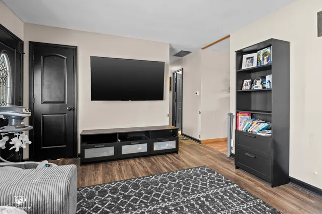 a kitchen with stainless steel appliances wooden floors and wooden cabinets