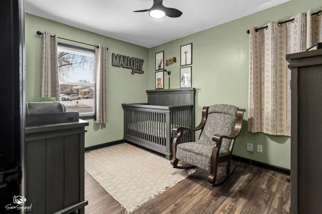 a view of a workspace with furniture and wooden floor