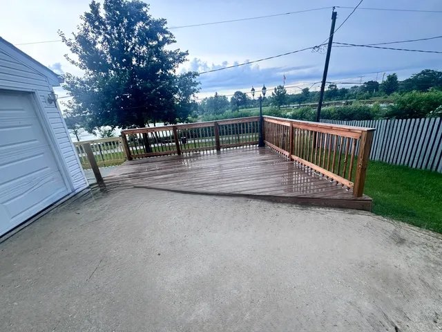 a view of balcony with wooden floor and fence