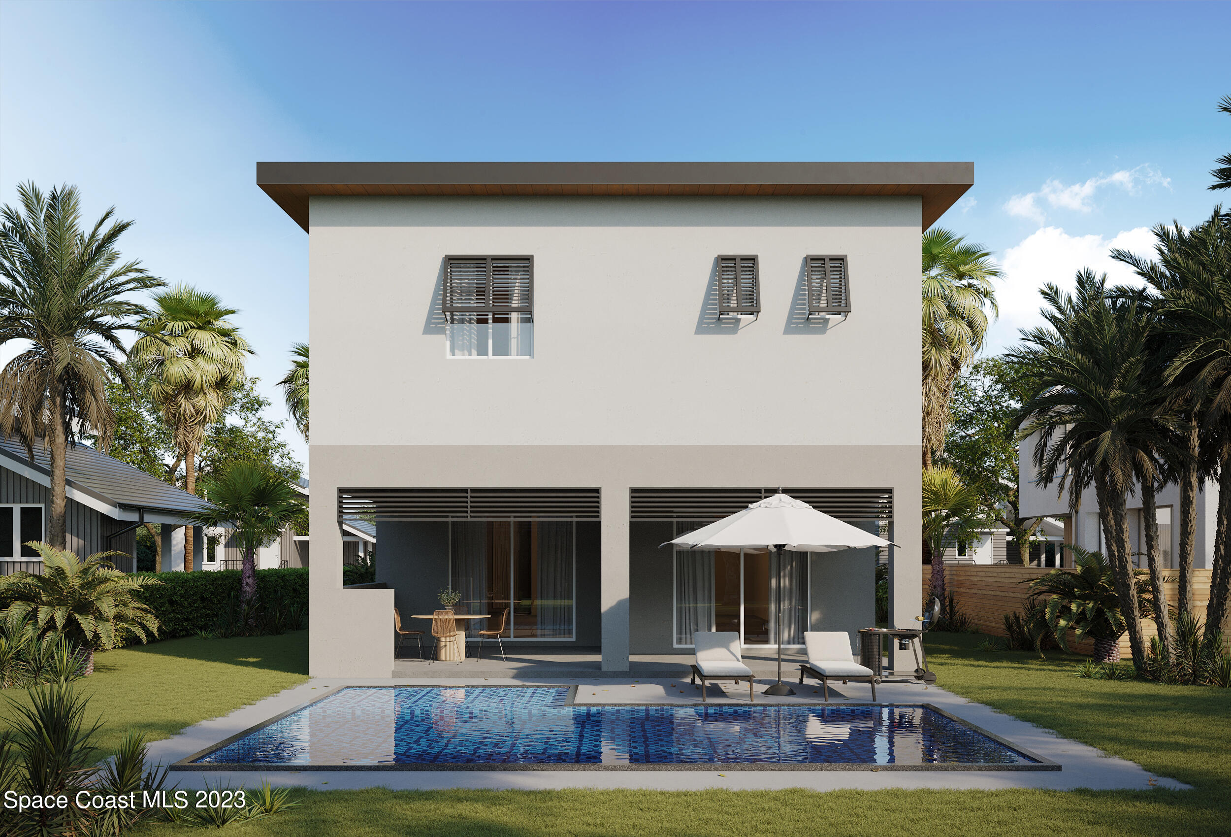 407 3rd Avenue Melbourne Beach, FL 32951 - Photo 3 of 14 a patio with a table and chairs under an umbrella