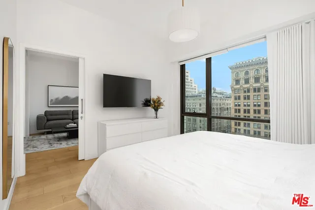 a bedroom with a bed and a flat screen tv