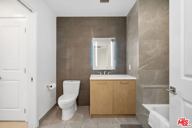 a bathroom with a toilet a sink and bathtub