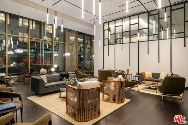 a living room with furniture and floor to ceiling windows