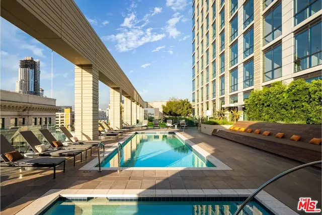 a view of a swimming pool with outdoor seating