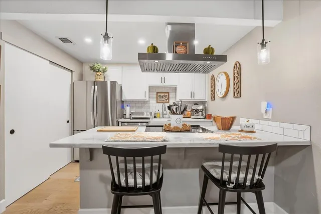 a kitchen with a dining table and chairs