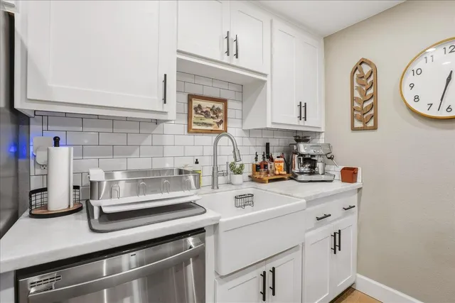 a kitchen with a sink cabinets and appliances
