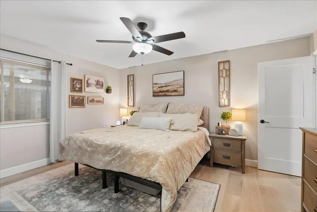 a bedroom with a bed and a flat tv screen on dresser