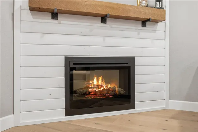 a living room with a fireplace and a flat screen tv