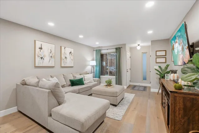 a living room with furniture and a potted plant