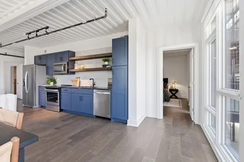 a view of a kitchen center island and wooden floor