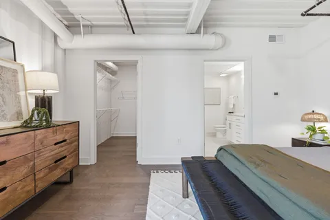 a bedroom with a bed and a dresser