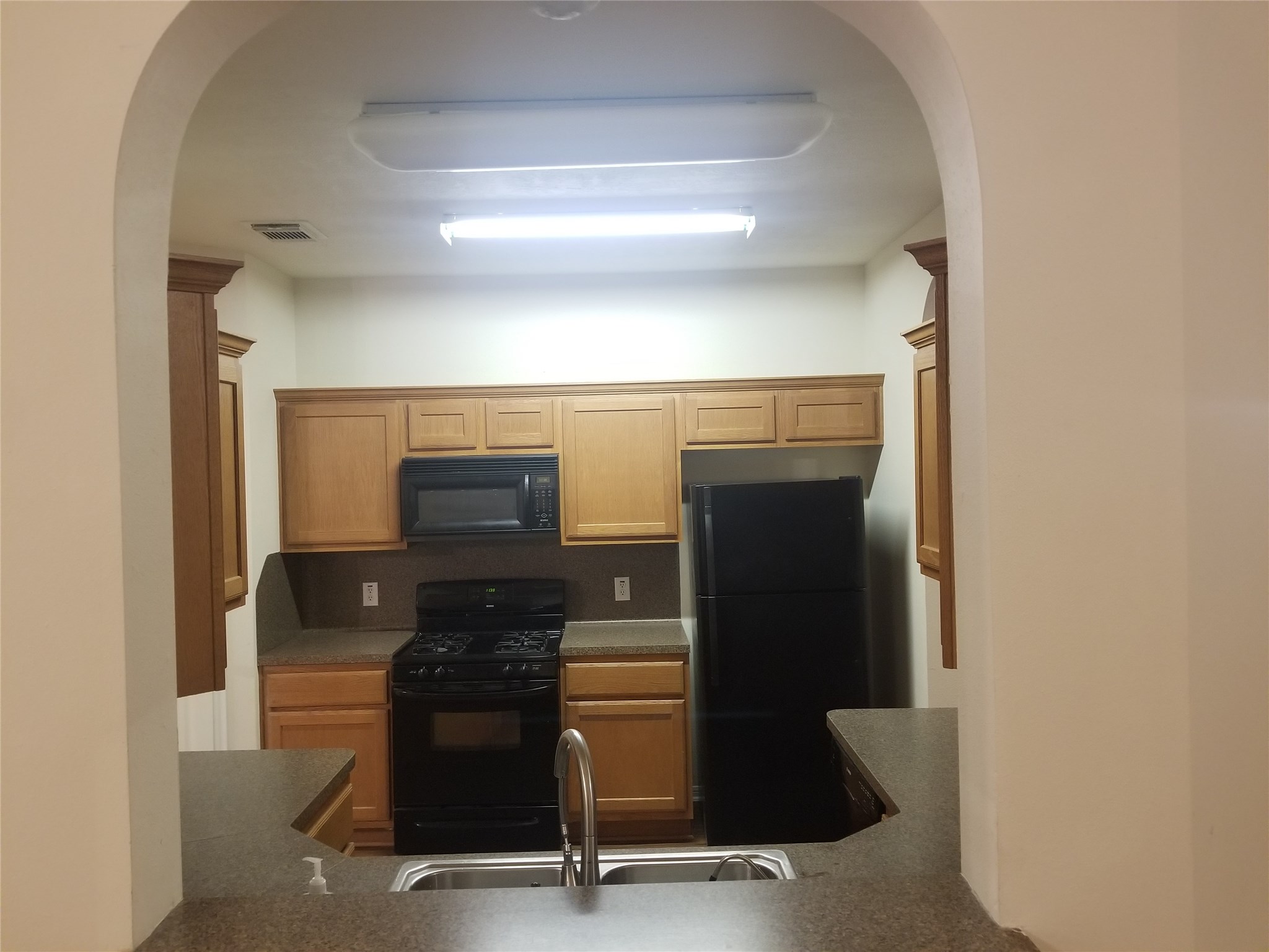 2406 Hawks Road Missouri City, TX 77489 - Photo 12 of 29 a kitchen with a refrigerator and a stove