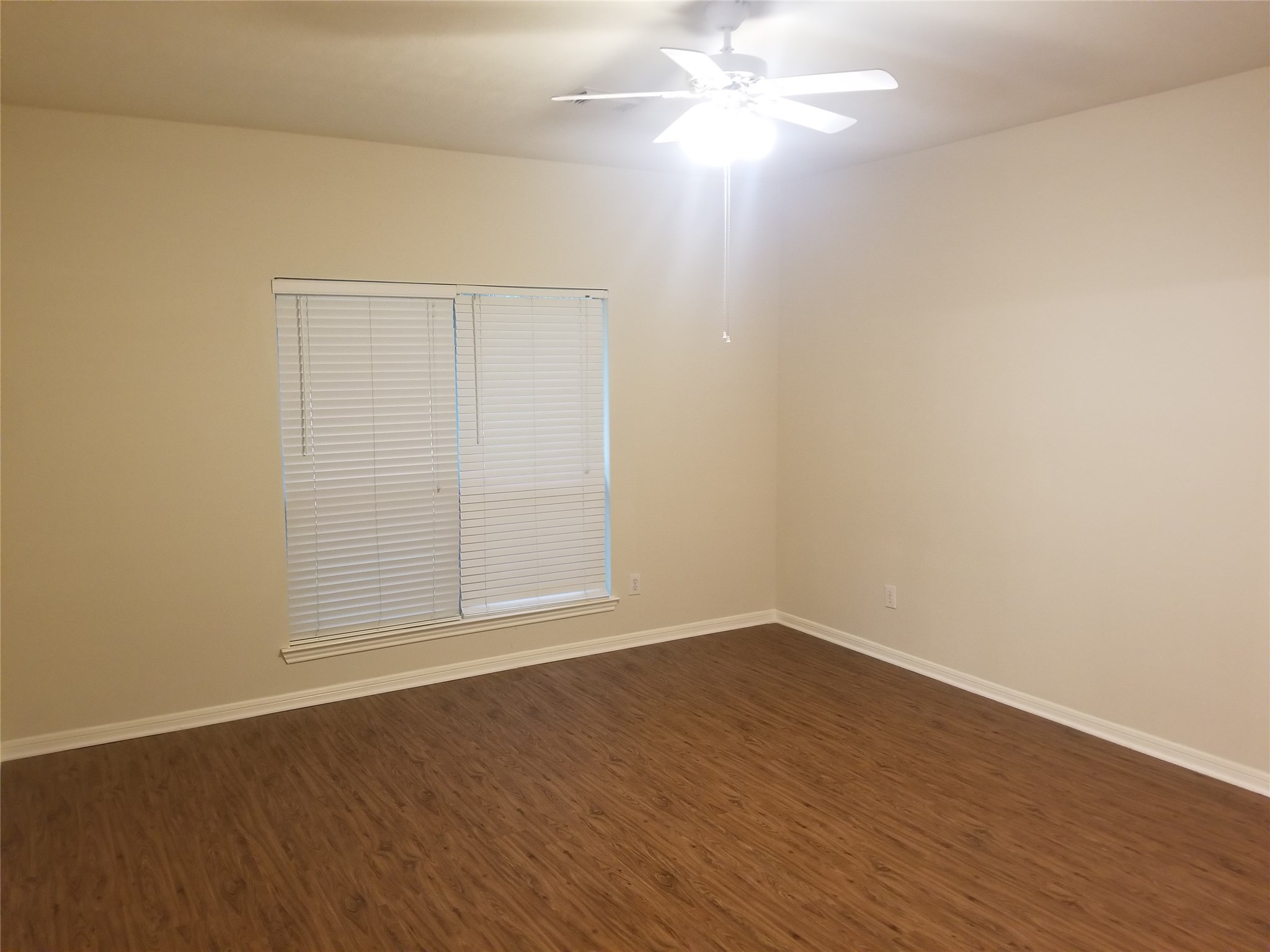 2406 Hawks Road Missouri City, TX 77489 - Photo 19 of 29 an empty room with wooden floor and windows