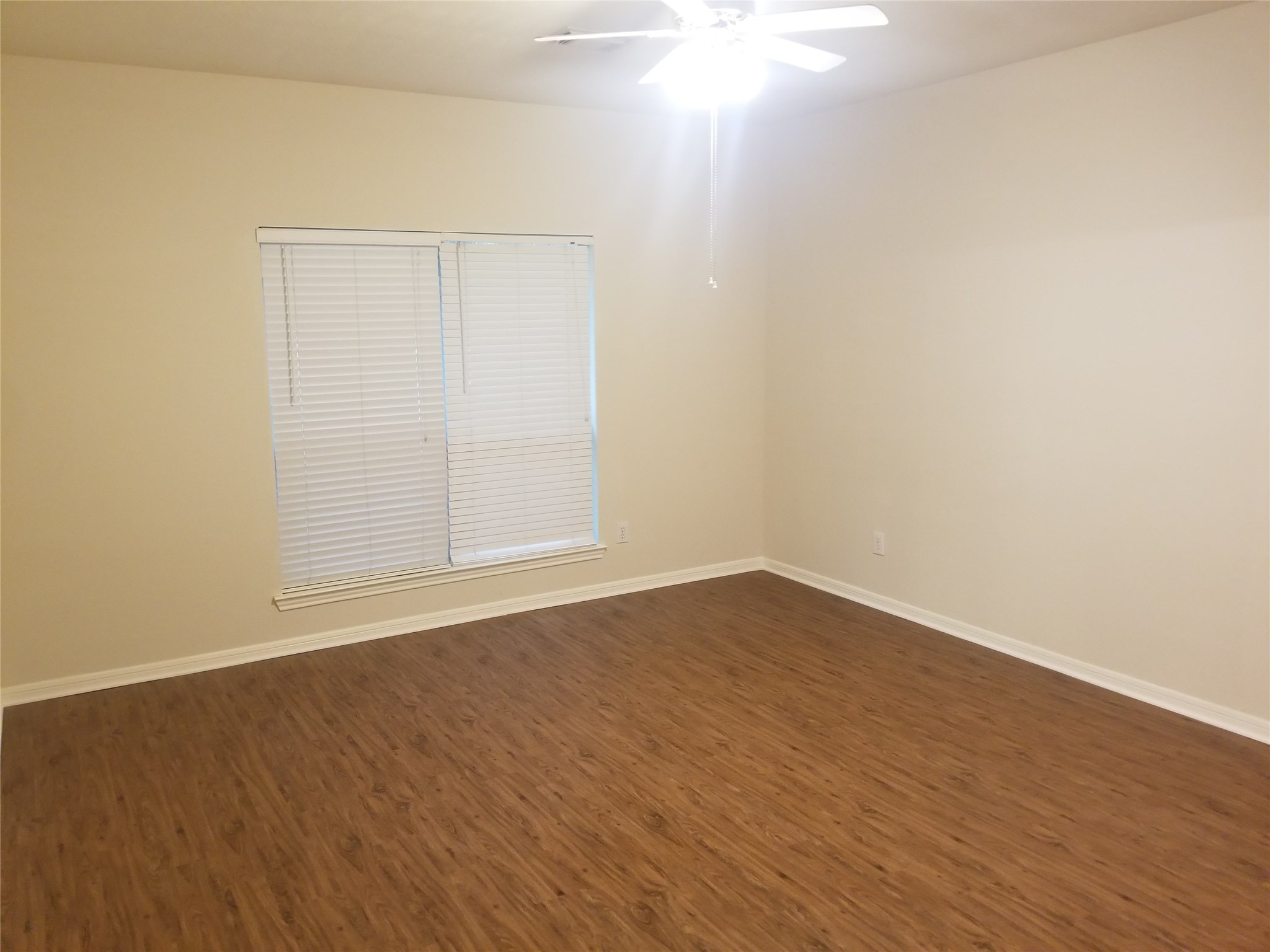 2406 Hawks Road Missouri City, TX 77489 - Photo 20 of 29 a view of an empty room with wooden floor