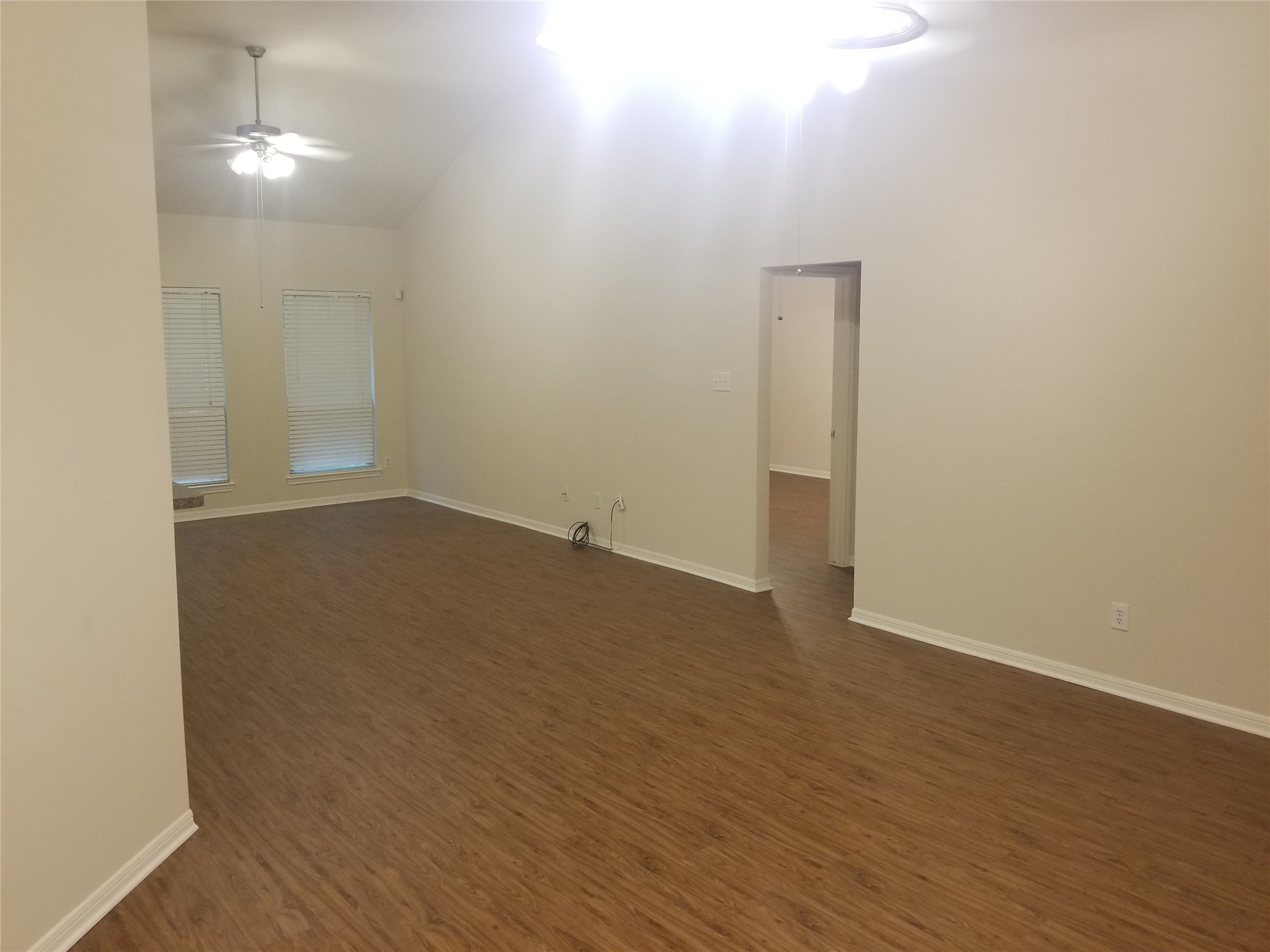 2406 Hawks Road Missouri City, TX 77489 - Photo 2 of 29 an empty room with wooden floor and windows