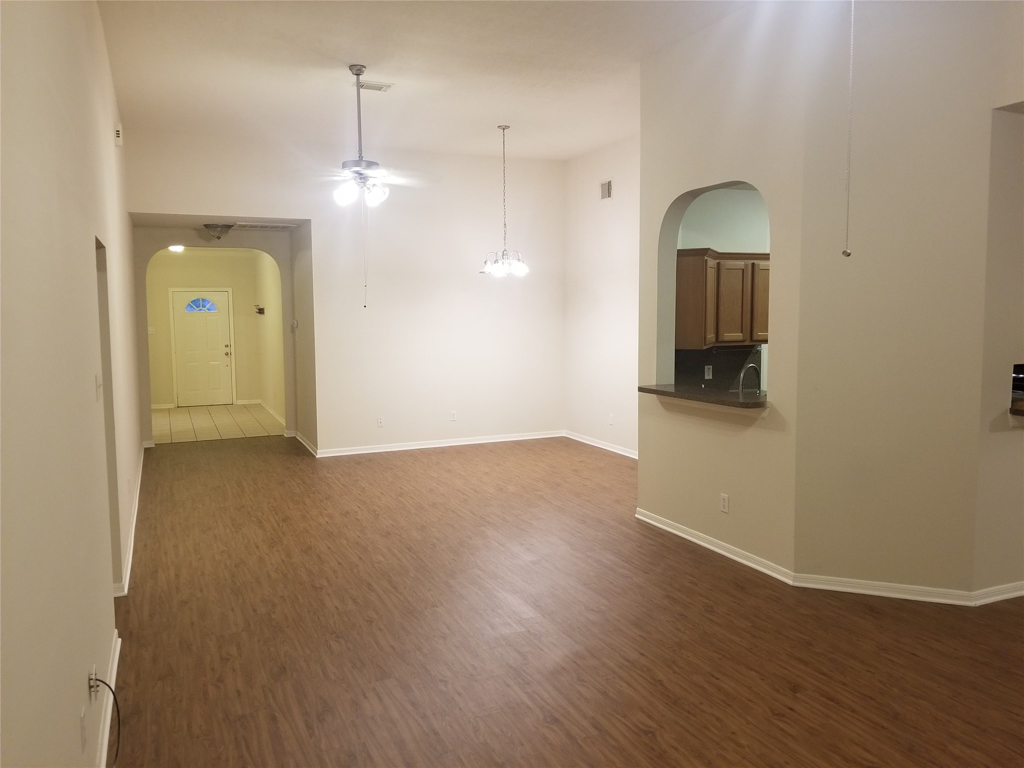 2406 Hawks Road Missouri City, TX 77489 - Photo 3 of 29 a view of empty room with wooden floor and kitchen