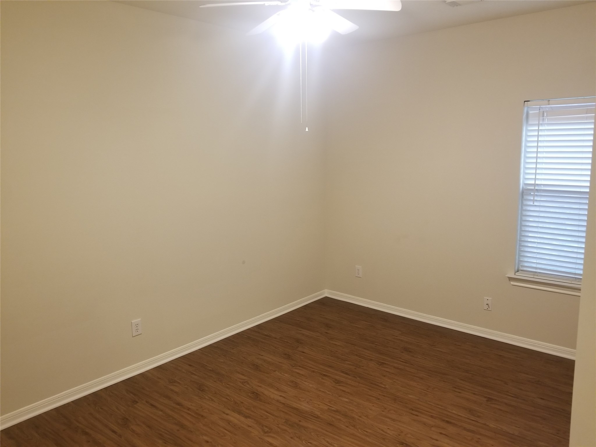 2406 Hawks Road Missouri City, TX 77489 - Photo 8 of 29 a view of a small space with wooden floor and a window
