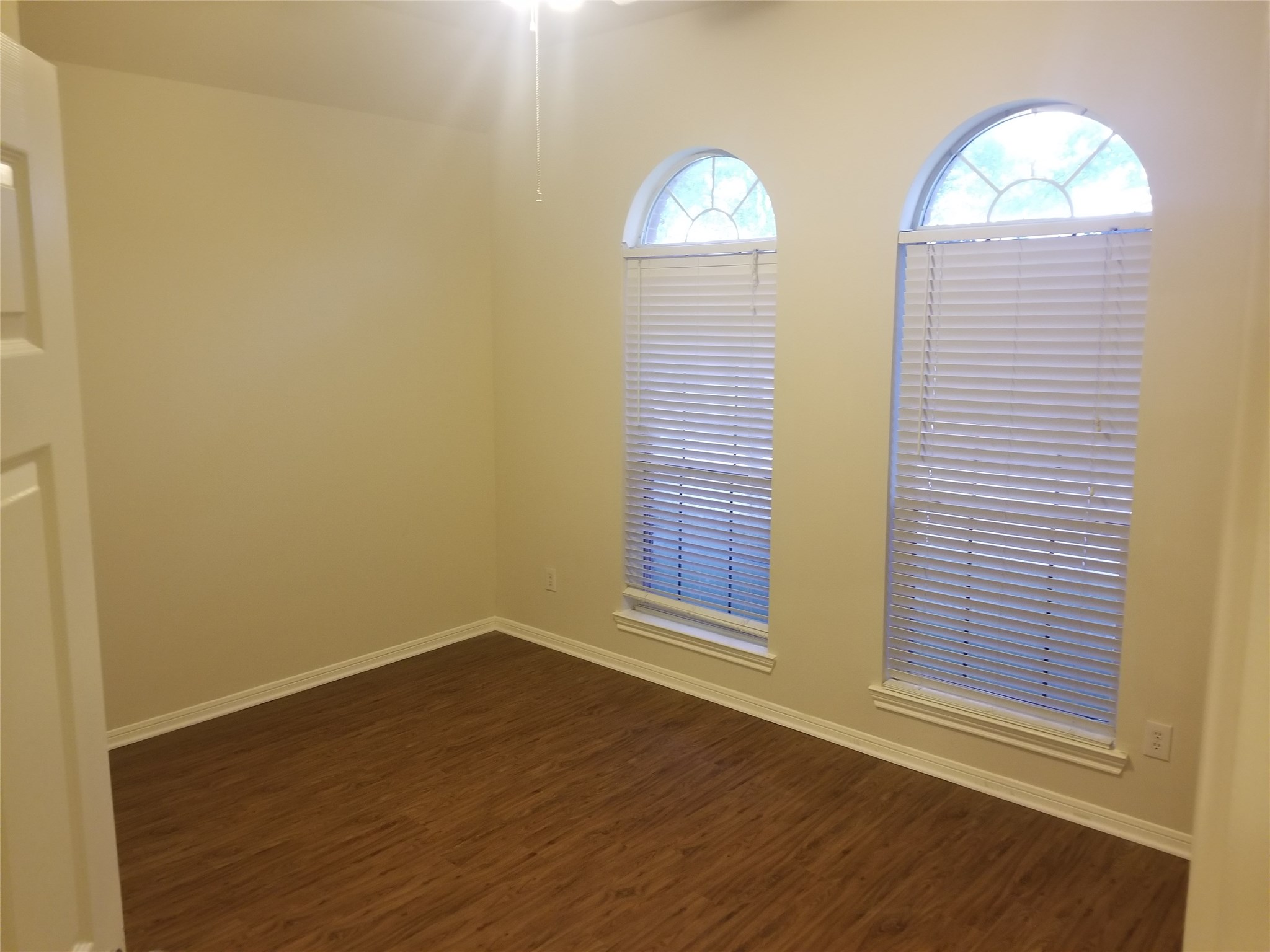 2406 Hawks Road Missouri City, TX 77489 - Photo 9 of 29 an empty room with wooden floor and windows