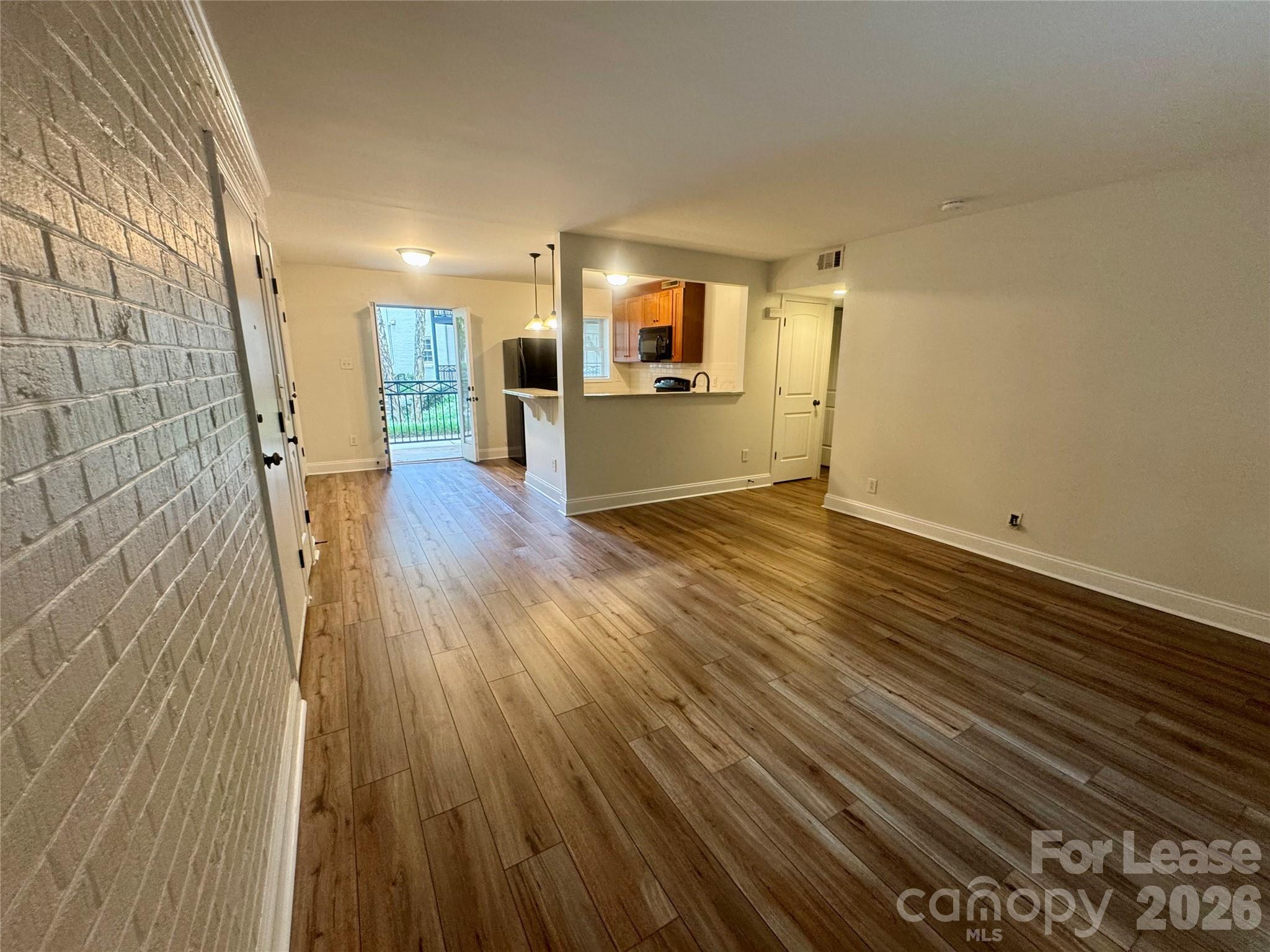 4917 Park Road, Unit B Charlotte, NC 28209 - Photo 9 of 24 a view of a big room with wooden floor and windows