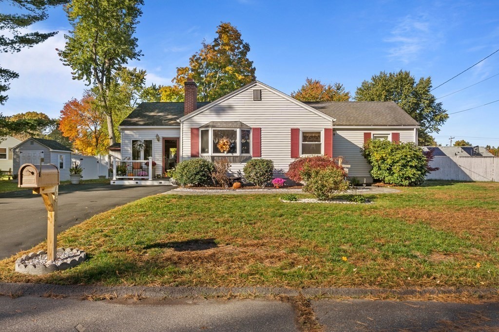 a front view of house with yard and green space