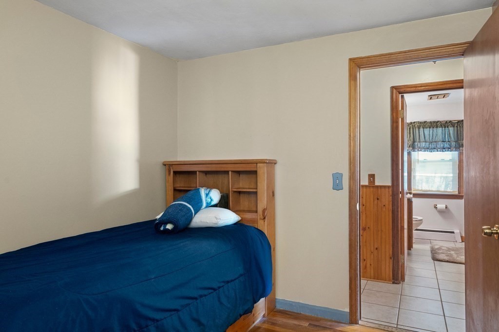 46 Timber Lane Springfield, MA 01119 - Photo 18 of 42 a bedroom with a bed and wooden floor