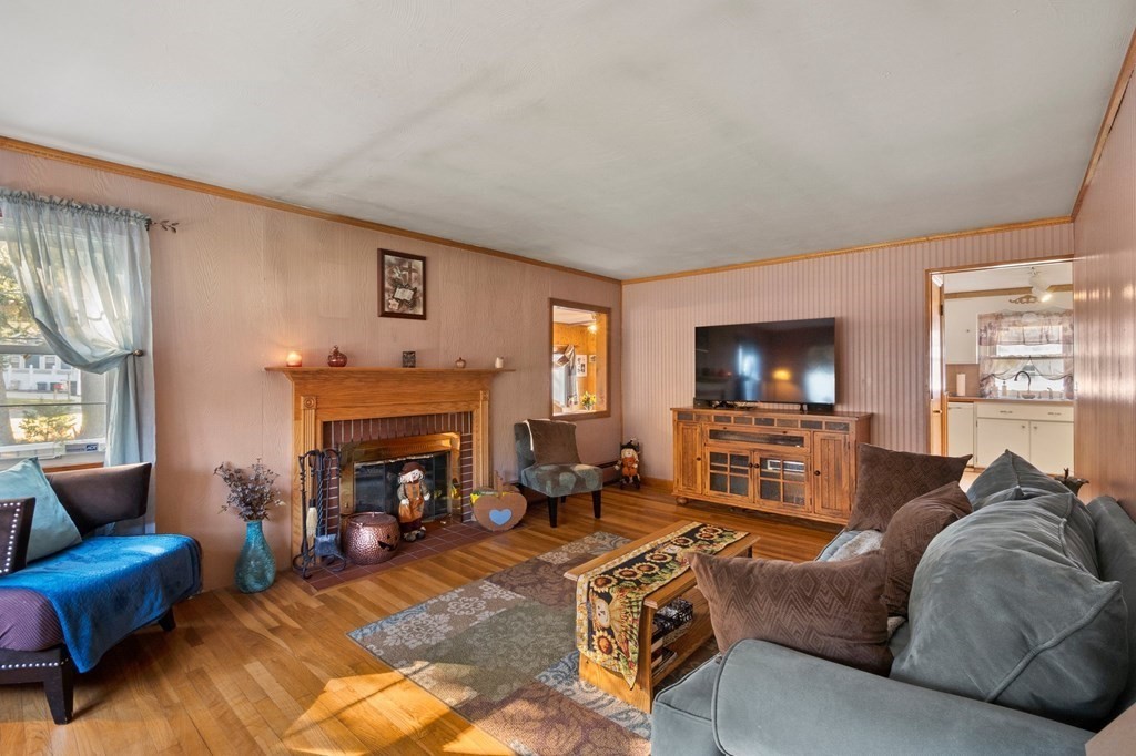 46 Timber Lane Springfield, MA 01119 - Photo 5 of 42 a living room with furniture a flat screen tv and a fireplace