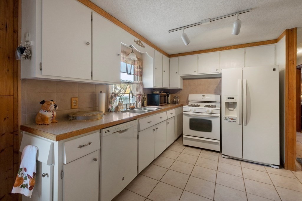 46 Timber Lane Springfield, MA 01119 - Photo 8 of 42 a kitchen with white cabinets and white appliances