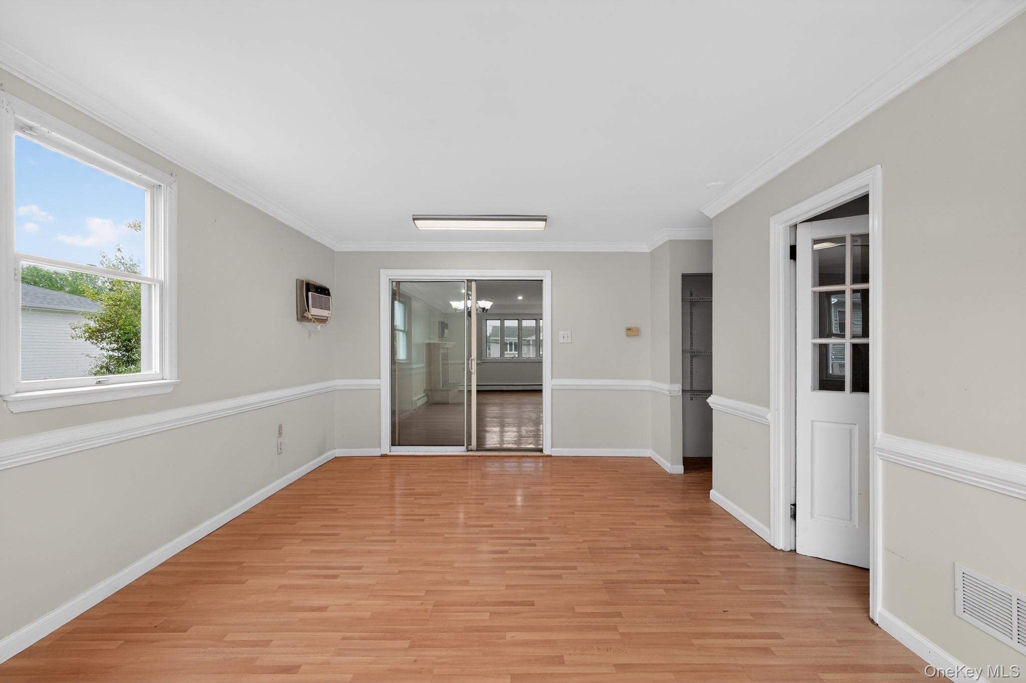 138 Spring Street Massapequa, NY 11758 - Photo 22 of 45 a big room with wooden floor and natural light