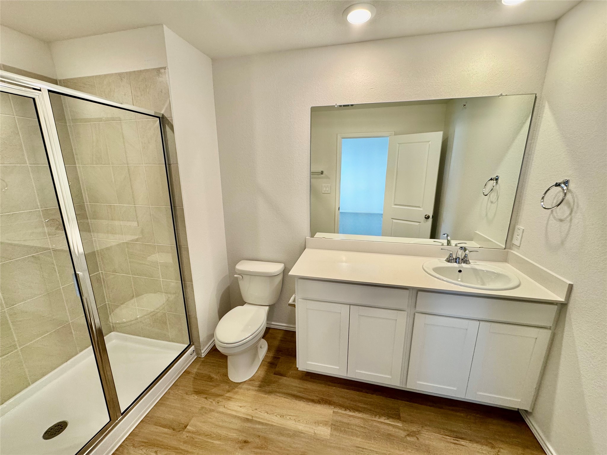105 Calcite Road, Unit 3 Kyle, TX 78640 - Photo 3 of 7 a bathroom with a sink a toilet a mirror and shower
