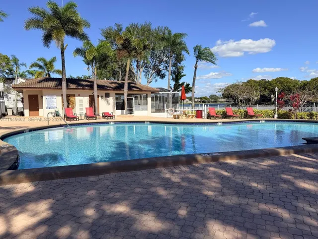 a swimming pool with outdoor seating and yard