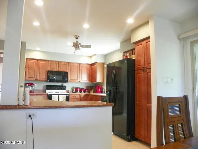 a kitchen with stainless steel appliances a refrigerator and a stove top oven