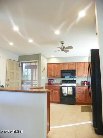 a kitchen with stainless steel appliances granite countertop a stove and a refrigerator