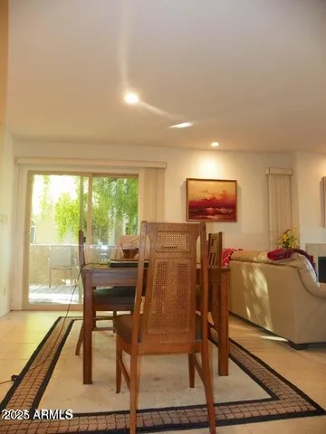 a living room with furniture a large window and a flat screen tv
