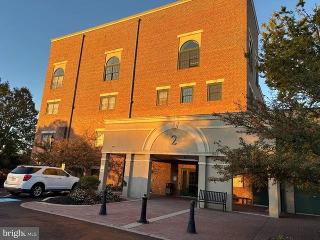 a view of building with car parked
