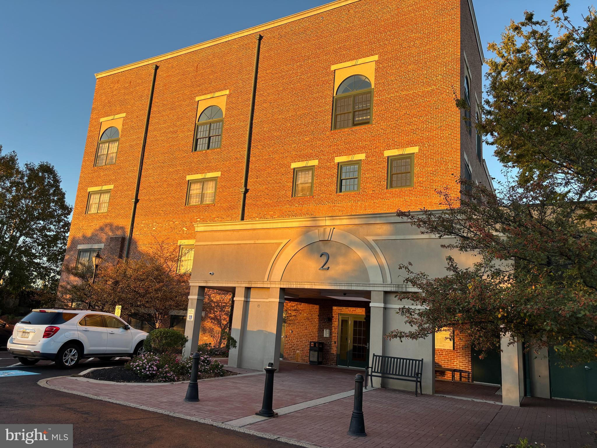 a view of building with car parked