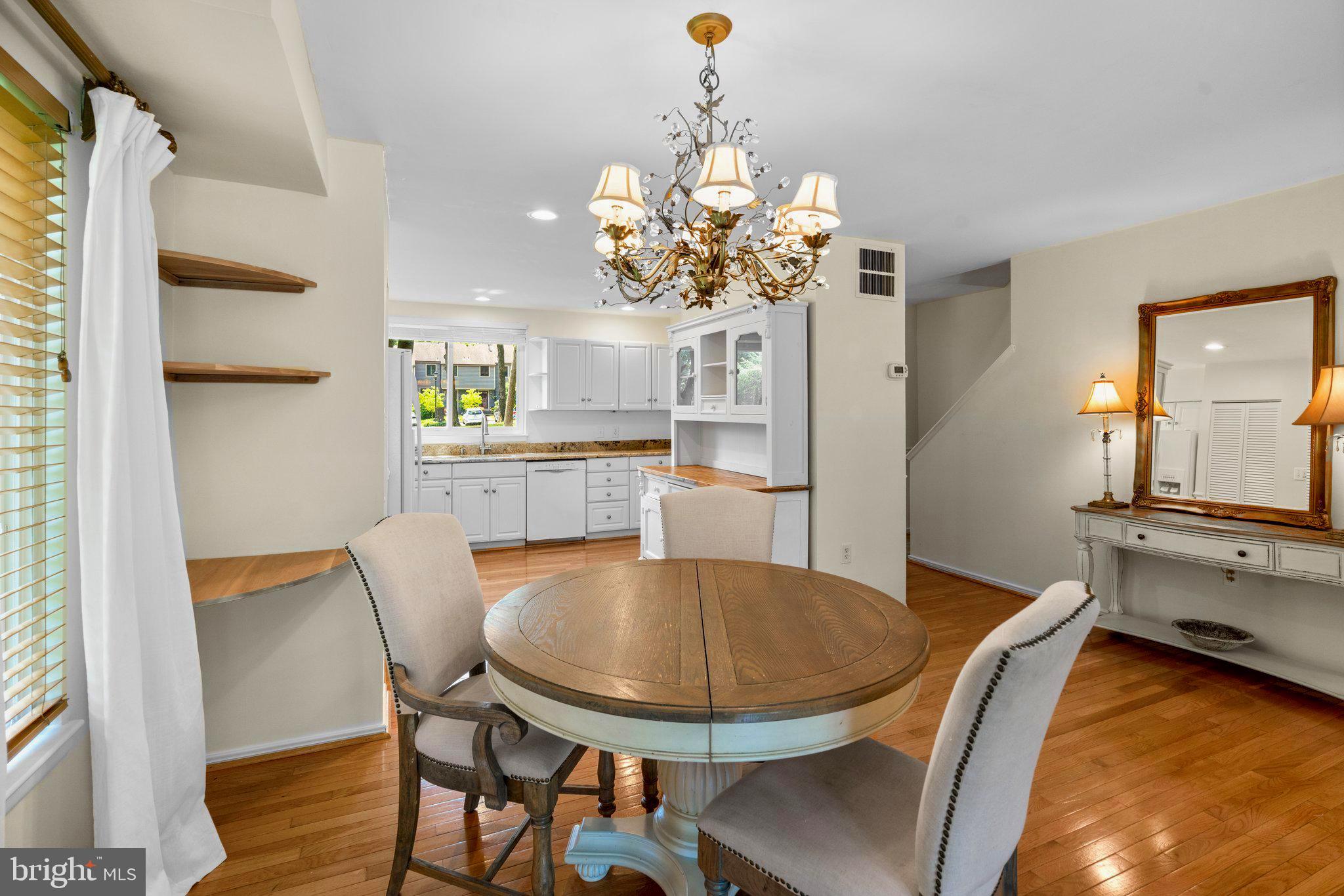 2 Stone Ridge Court Baltimore, MD 21239 - Photo 12 of 45 a dining room filled chandelier and wooden floor