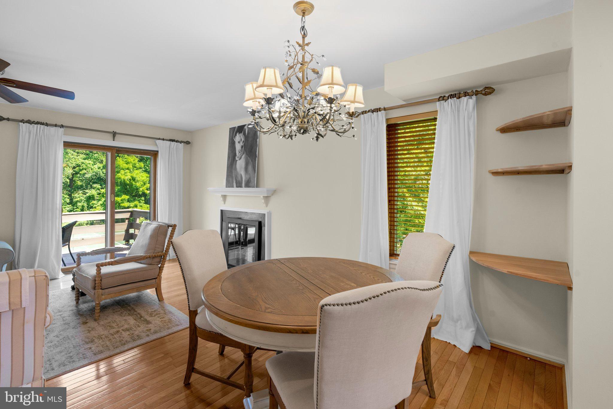 2 Stone Ridge Court Baltimore, MD 21239 - Photo 13 of 45 a view of a dining room with furniture a chandelier and wooden floor