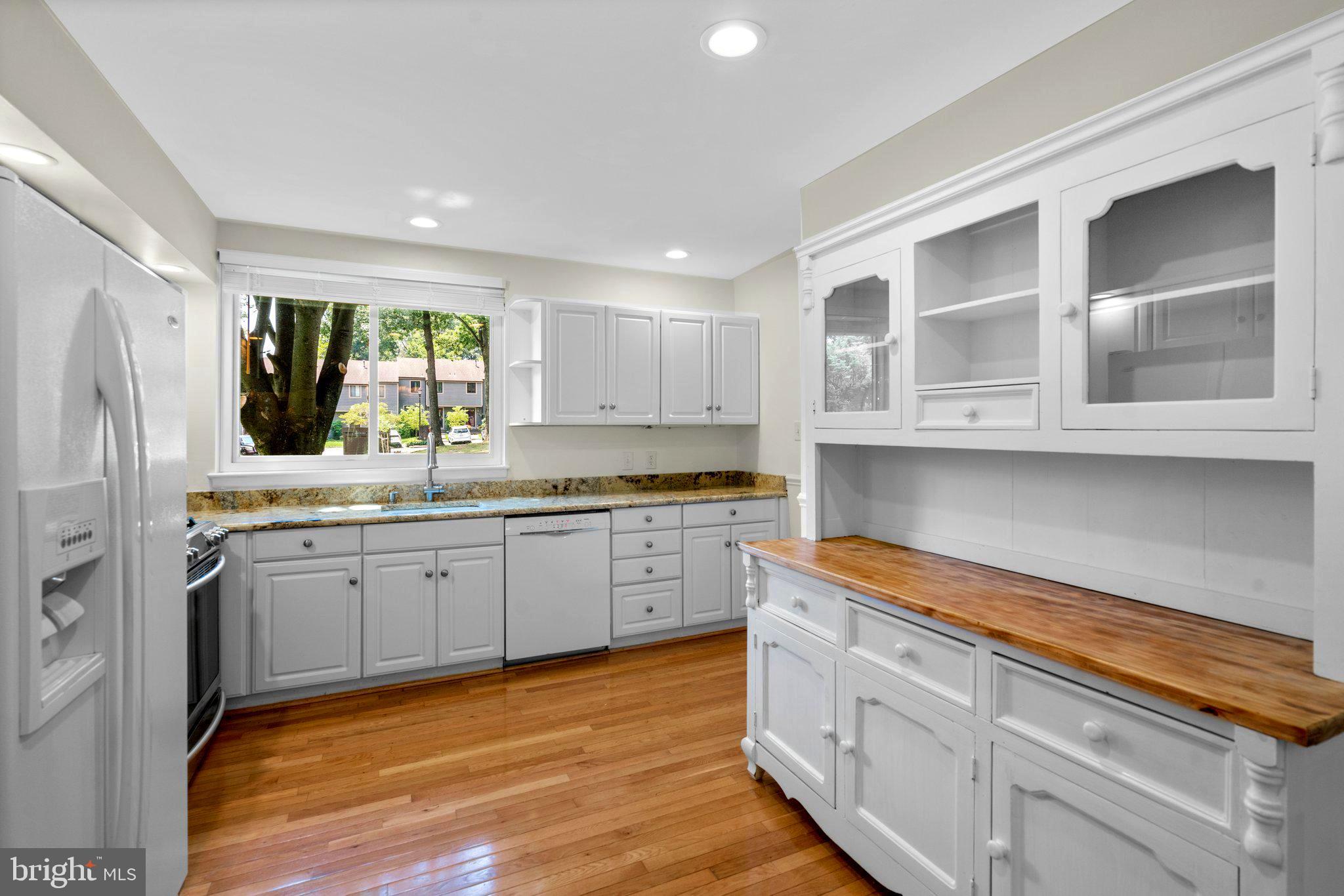 2 Stone Ridge Court Baltimore, MD 21239 - Photo 15 of 45 a kitchen with stainless steel appliances granite countertop white cabinets granite counter tops and a window