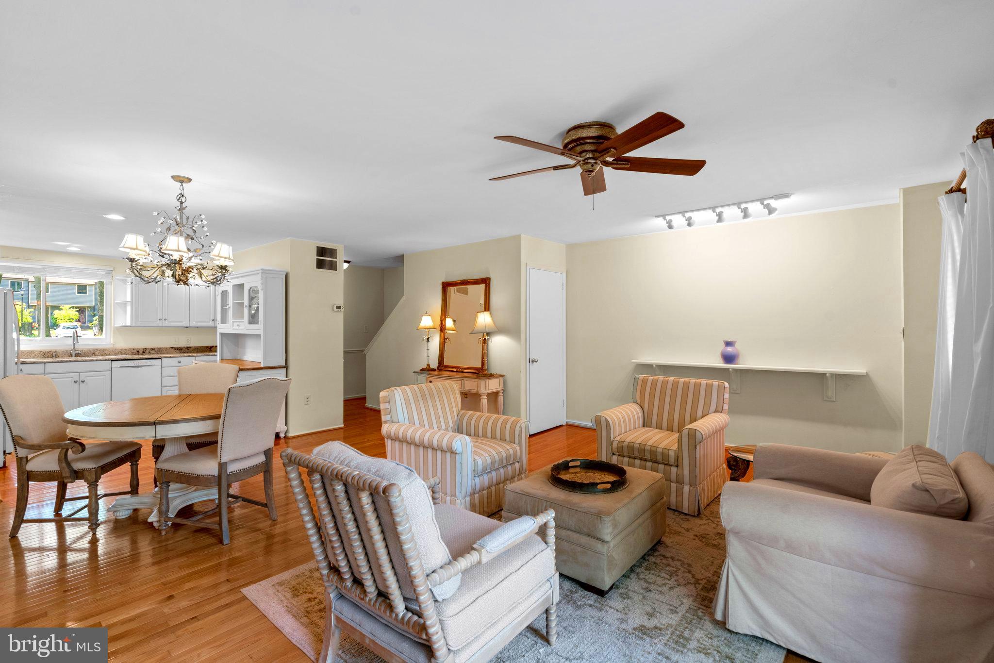 2 Stone Ridge Court Baltimore, MD 21239 - Photo 8 of 45 a living room with furniture a chandelier and a dining table