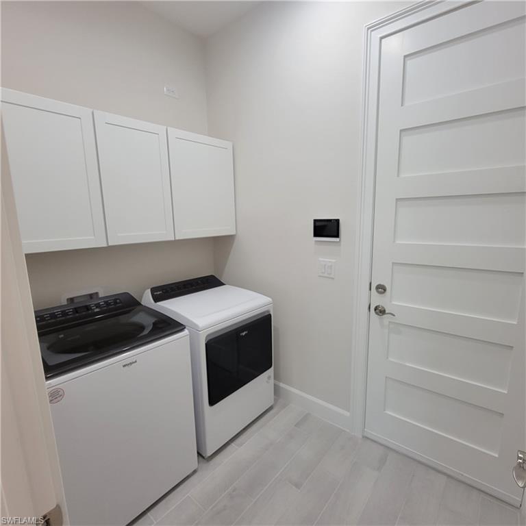 6378 Negril Isle Drive Naples, FL 34113 - Photo 15 of 15 a view of storage and utility room with washer and dryer