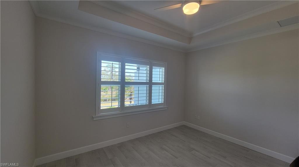 6378 Negril Isle Drive Naples, FL 34113 - Photo 7 of 15 an empty room with window and windows