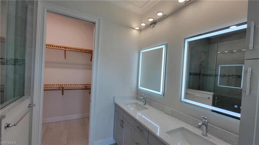 6378 Negril Isle Drive Naples, FL 34113 - Photo 8 of 15 a bathroom with a shower sink and mirror