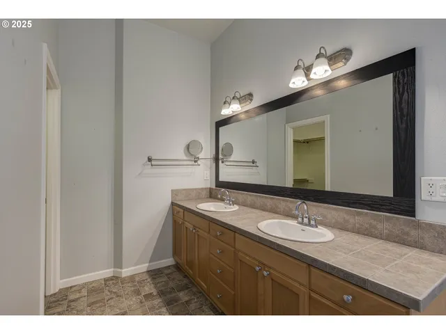 a bathroom with a sink vanity and mirror