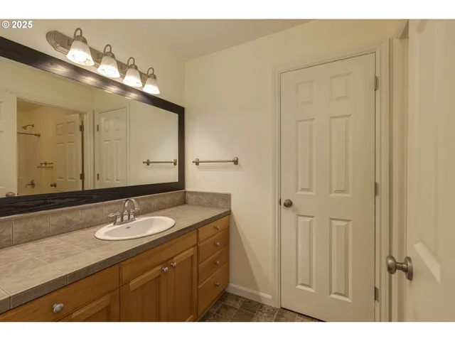 a bathroom with a sink vanity and a mirror